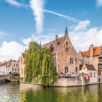 Panoramic city view with historical houses, church, Belfry tower